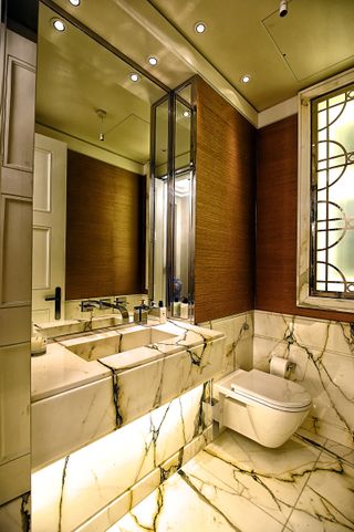 marble bathroom with mirror lighting