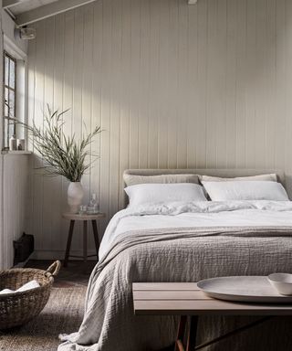 Organic Hemp Sheets on a bed against a beige wall.