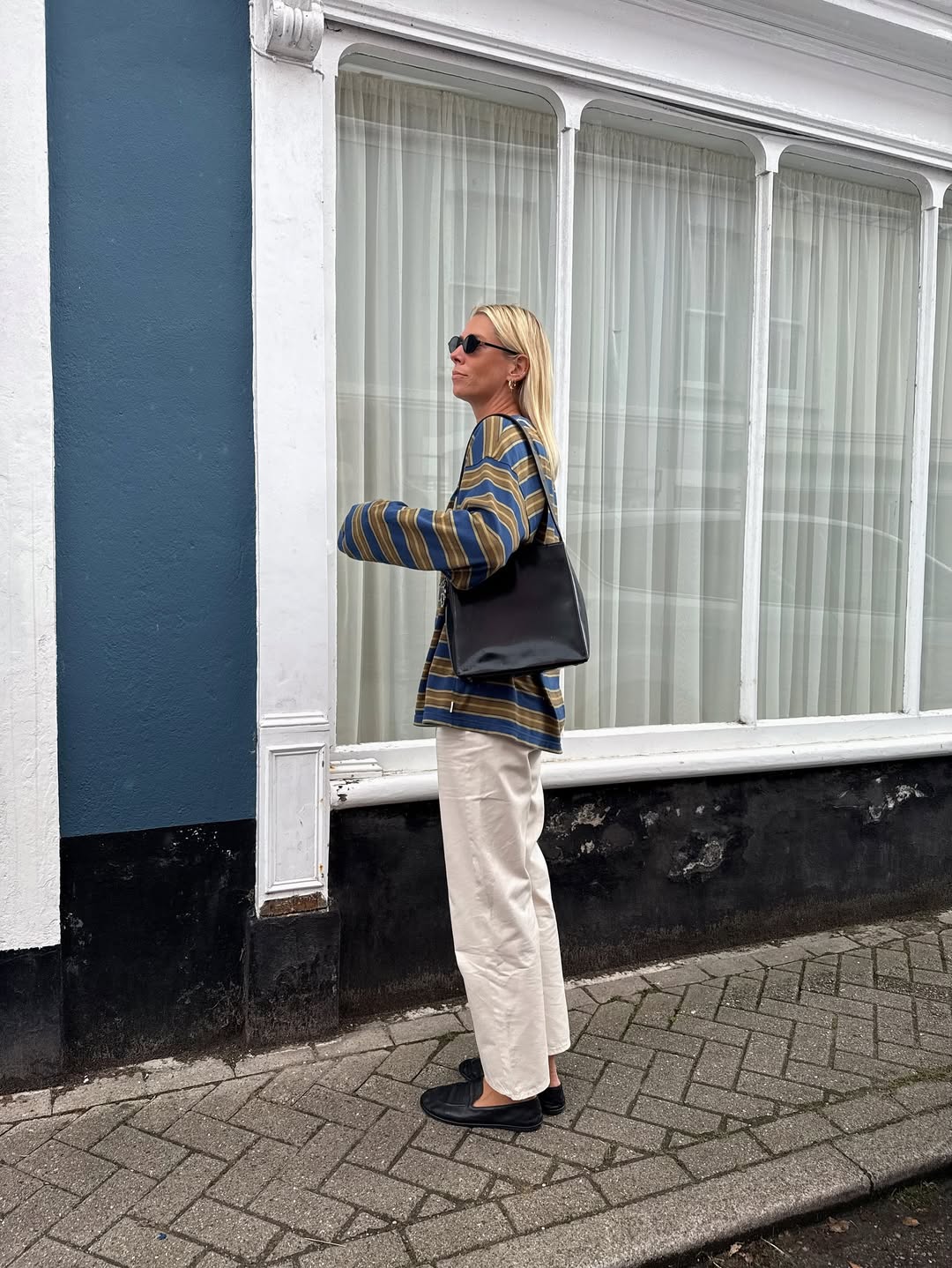 Lindsey in white jeans, striped top and black loafers