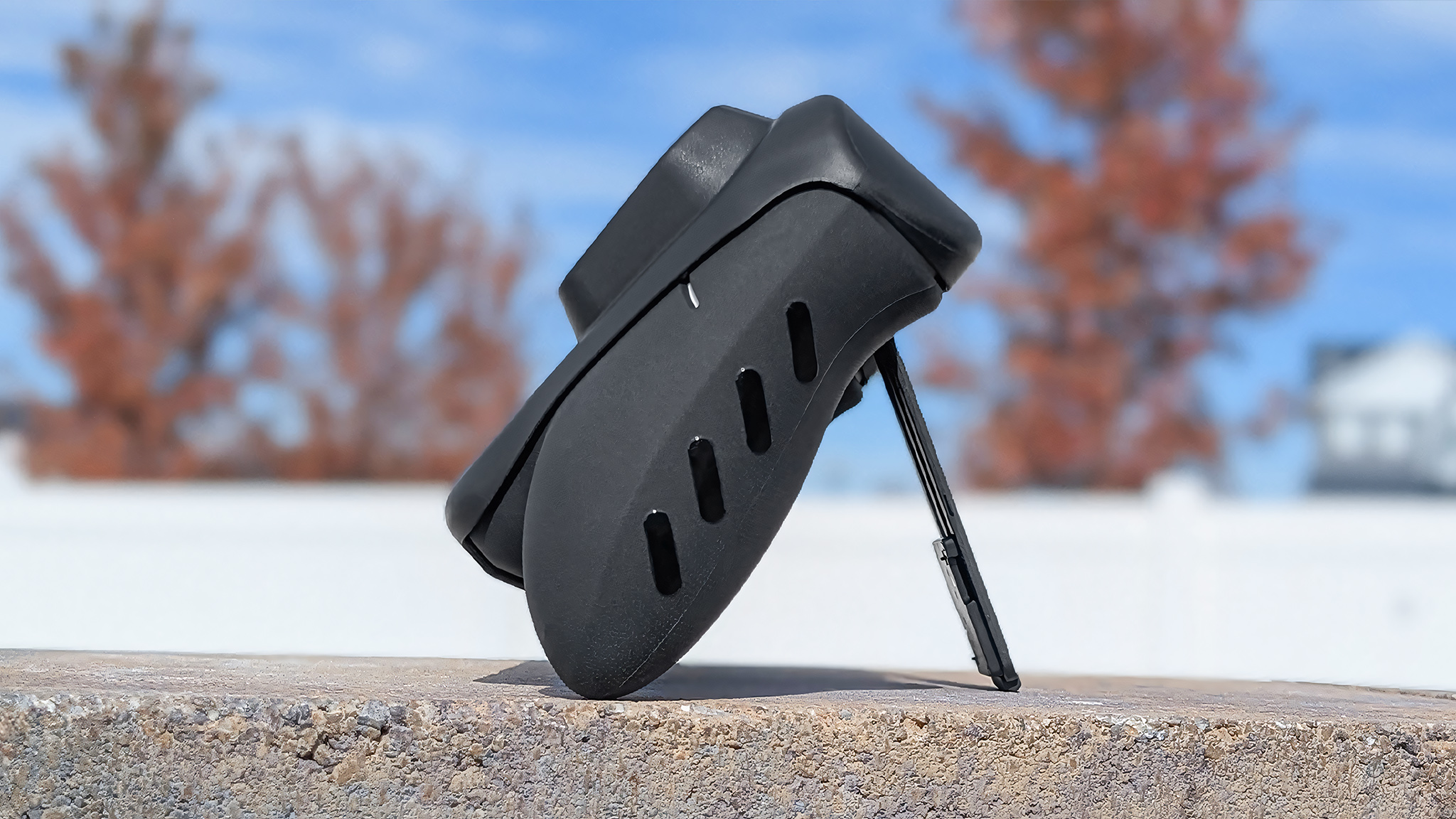 A profile view of the dBrand Killswitch installed on the Xbox Ally while it's laying back on its kickstand.