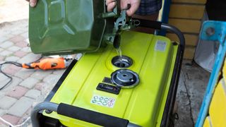 A portable generator being filled with fuel
