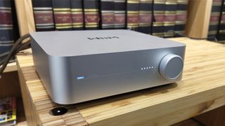 WiiM Amp streaming amplifier from front slight angle on hi-fi rack