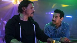 Sergio Peris-Mencheta as Gustavo and Alejandro Edda as Rubén sitting at a bar in Snowfall season 6