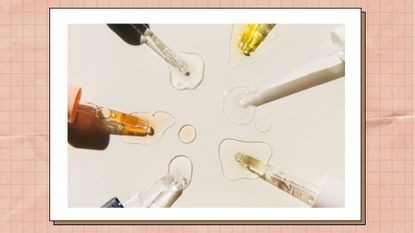 Pipettes with drops of cosmetic liquid on beige background