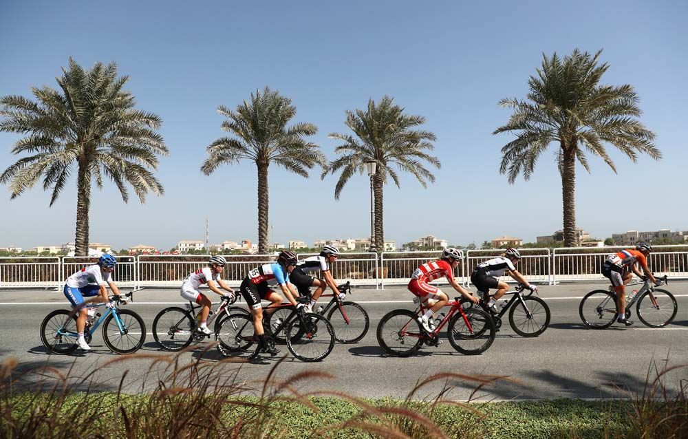 The junior women race past some palm trees