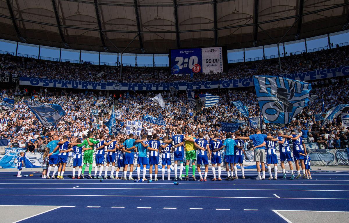 Hertha Berlin players celebrate a win at the Olympiastadion with their fans, August 2024