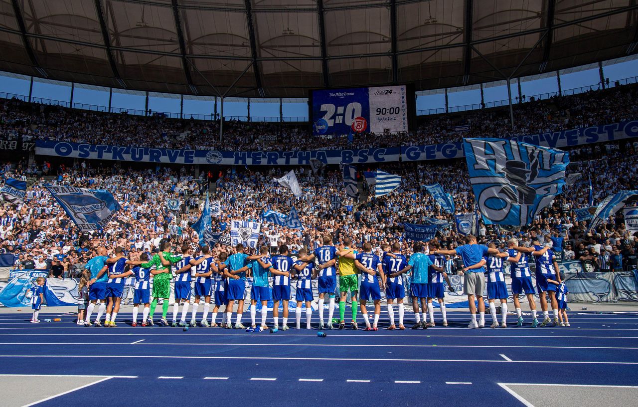 Hertha Berlin players celebrate a win at the Olympiastadion with their fans, August 2024
