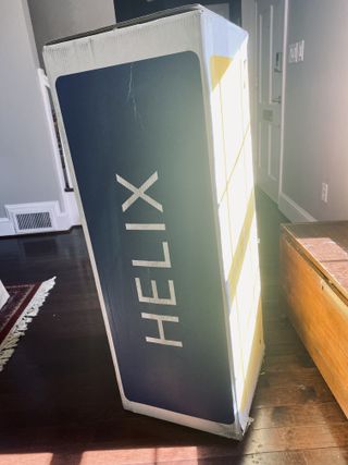A Helix Midnight Mattress in its box