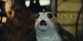 A Porg annoying Chewie while he's trying to drive.