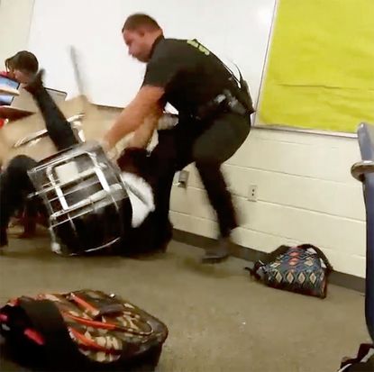 A video captured a student being thrown across a room by a police officer.