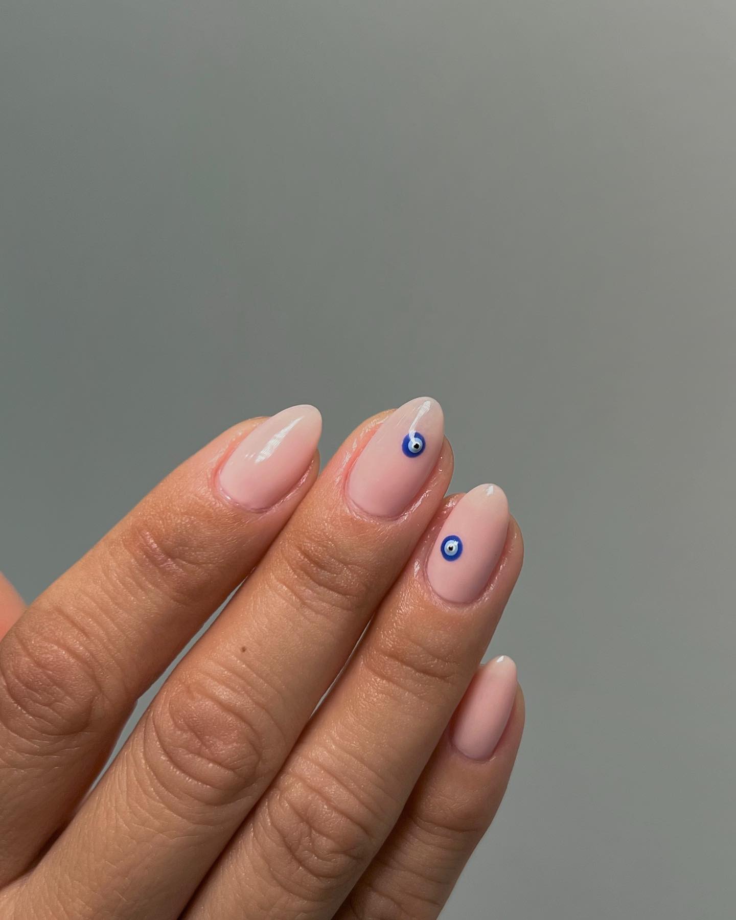 Photo of minimalist evil eye nail art