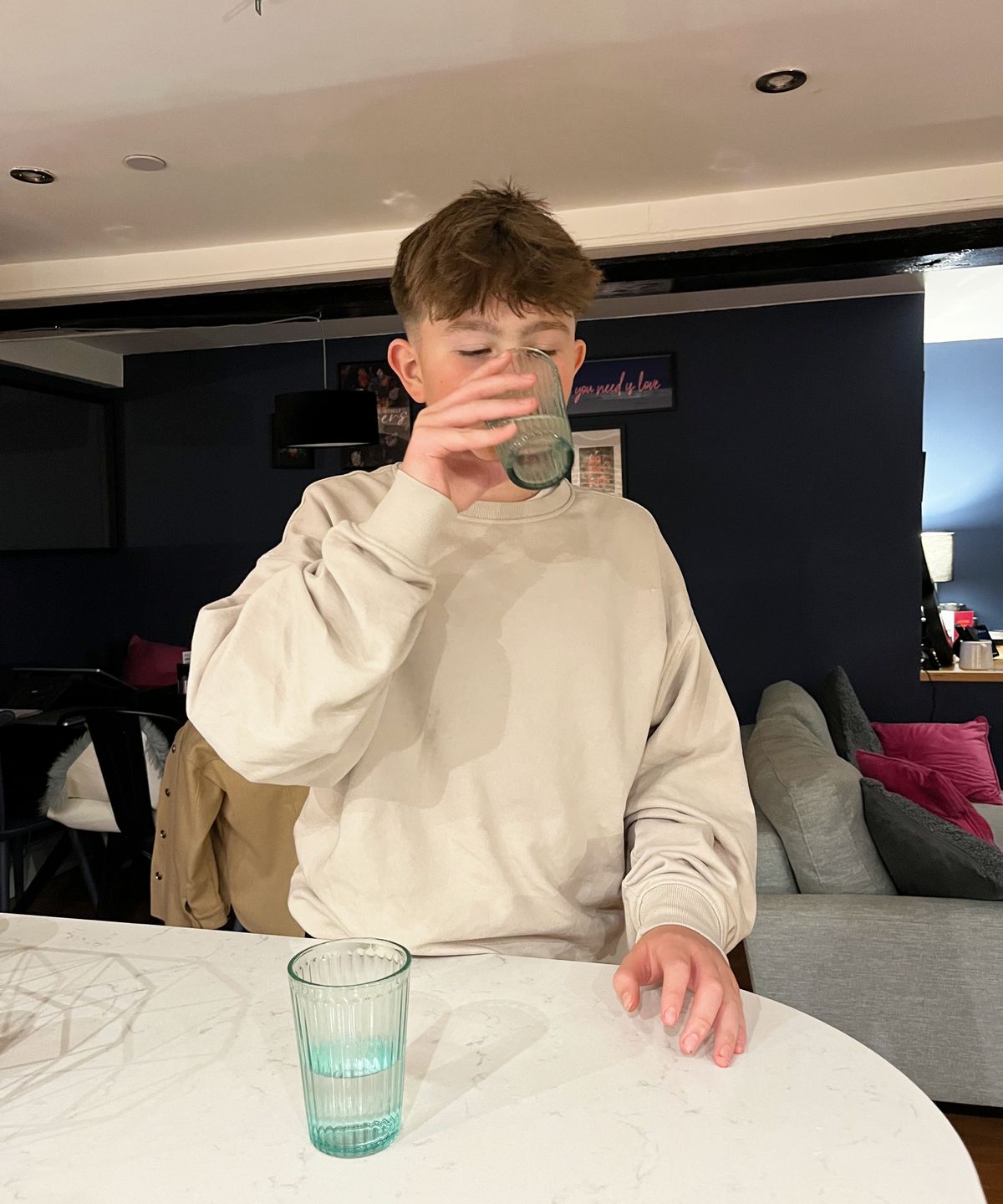 glasses of water on worktop, followed by boy smelling and tasting water