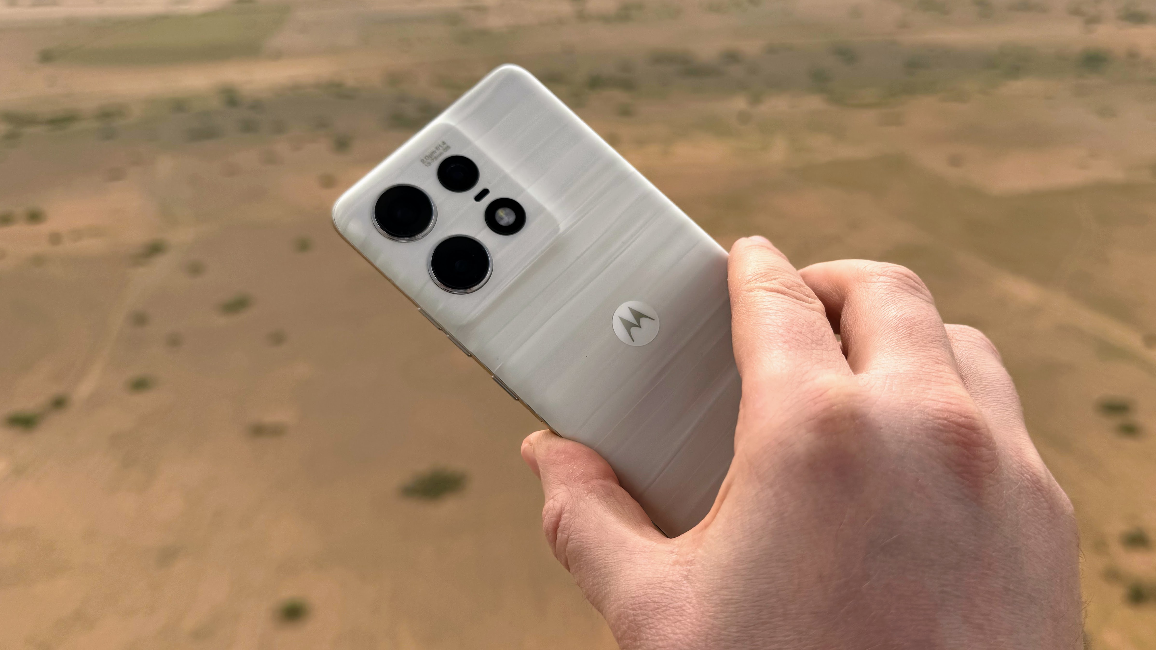 An image of the Moto Edge 50 Pro over a desert