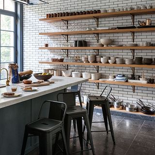 kitchen wall with white tiles and open crockery shelf