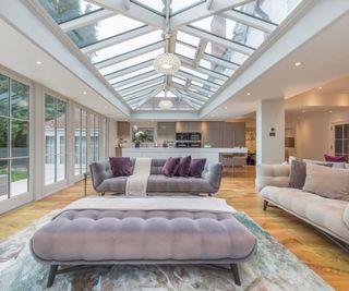 large pink and lilac sofas in white conservatory