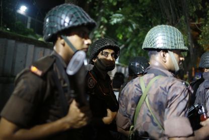 Security forces surround a restaurant in Dhaka.