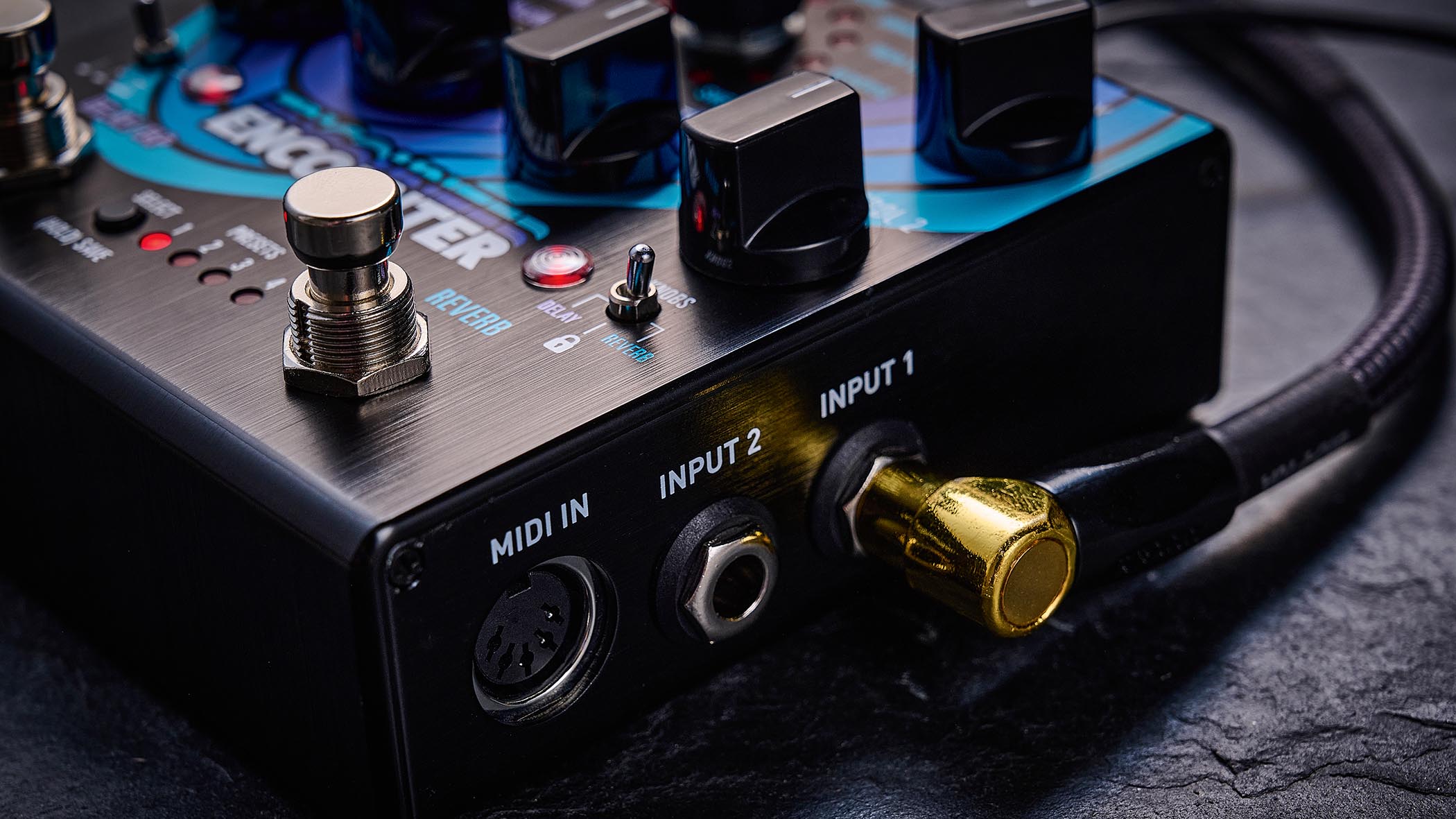 The Source Audio delay/reverb is photographed in close-up up against a slate background.