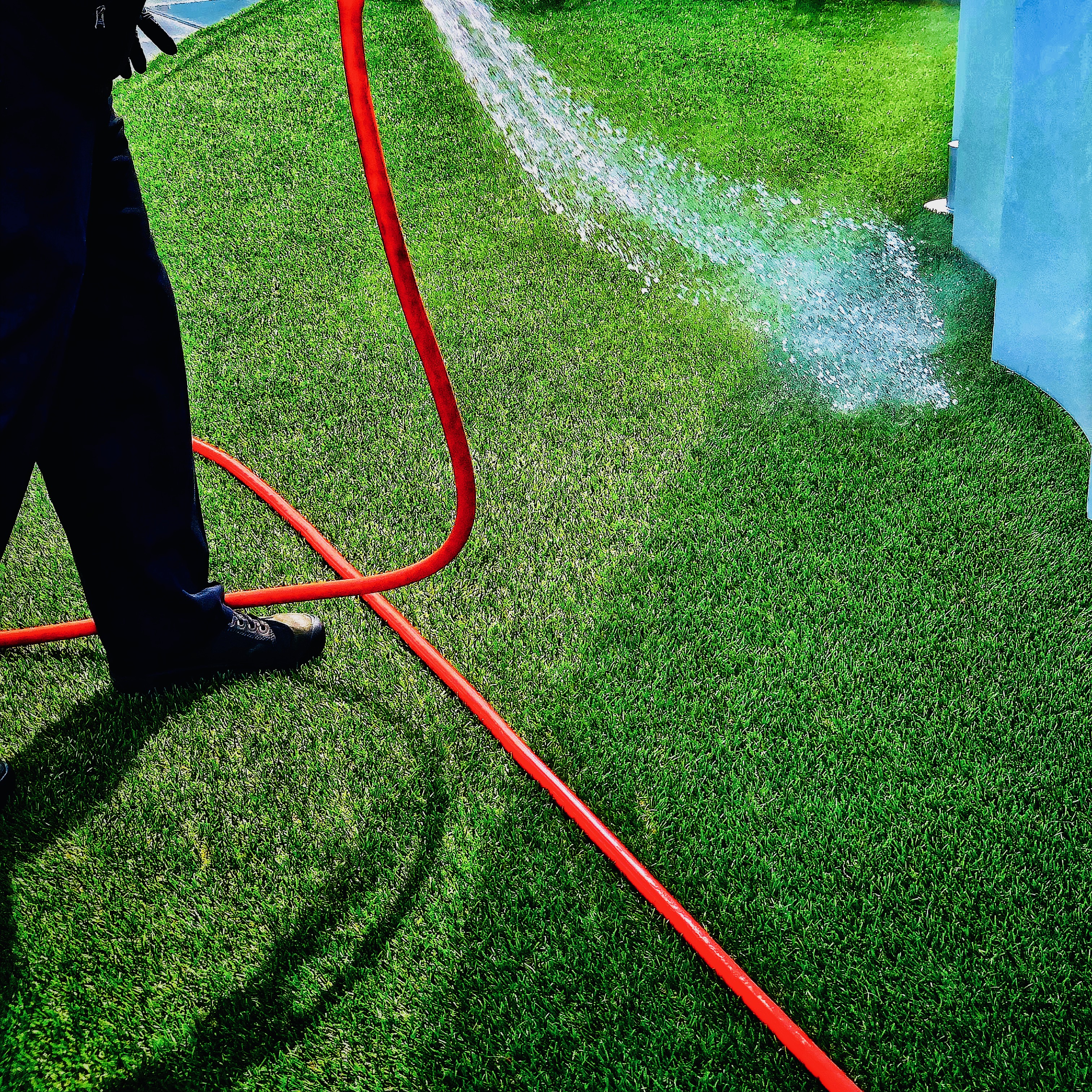 Shot of landscaper using hose for iPhone Photography Awards 2021