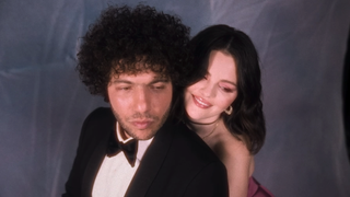 Benny Blanco and Selena Gomez posing next to each other in Talk music video