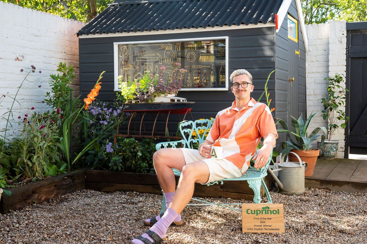 'The Frankenshed' is a black shed and Archie is sitting in front of it with his award