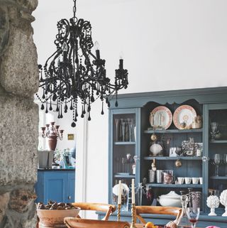 kitchen with gothic chandelier and crockery cupboard