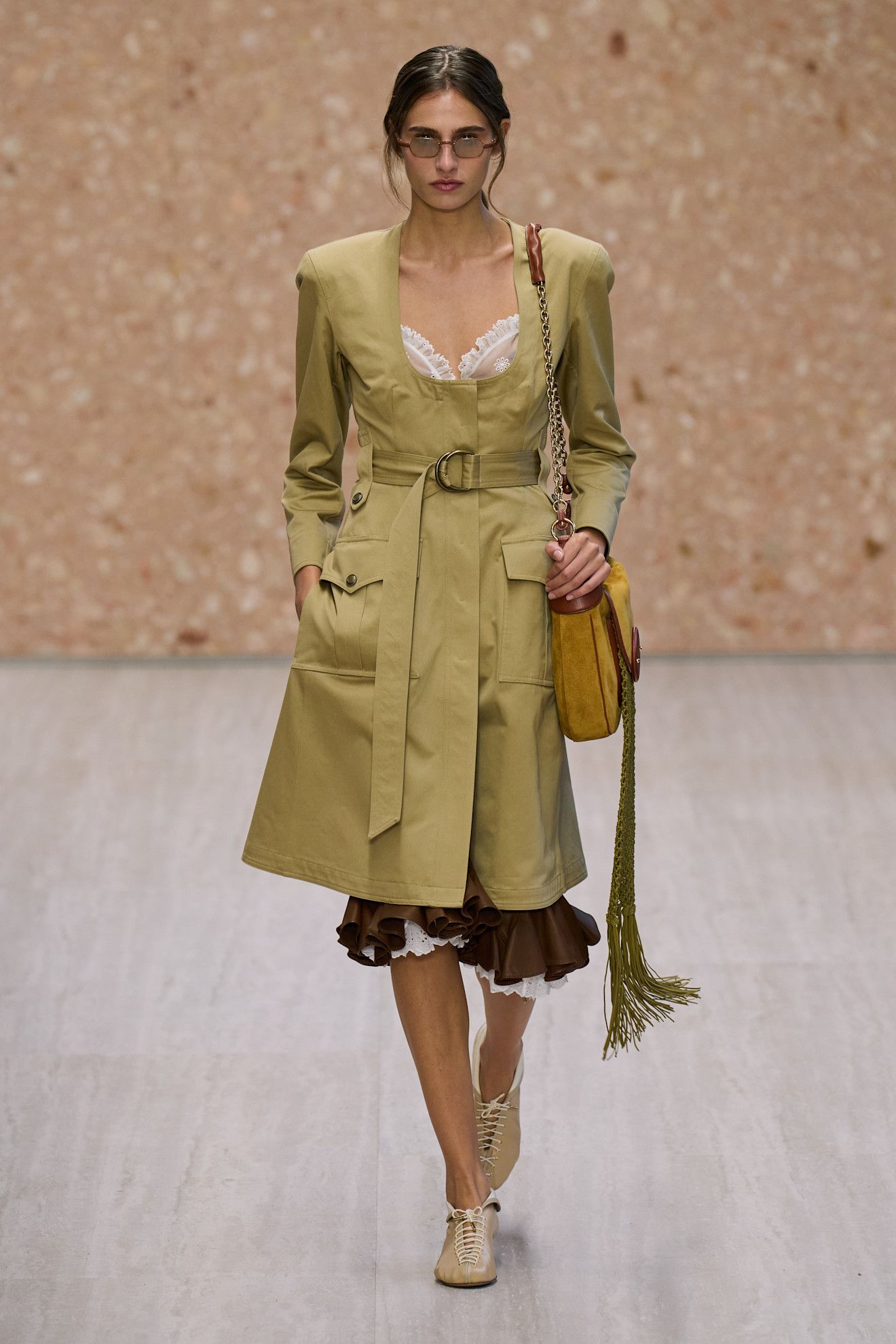 chloe spring summer 2027 runway review: model wears a camel scoop neck trench coat and lace up flats