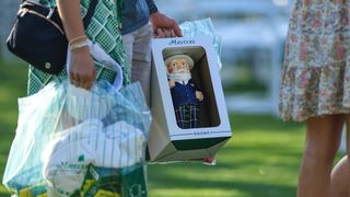 A detailed photograph of a patron's shopping including the popular Gnome during a practice round prior to the 2024 Masters Tournament