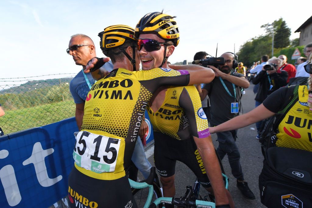 Roglic celebrates with his teammates after the finish