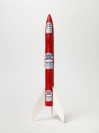 Model rocket, red and white with Budweiser motifs, white background