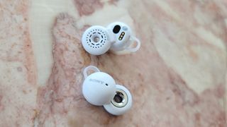 The Sony LinkBuds WF-L900 wireless earbuds displayed on a marble surface