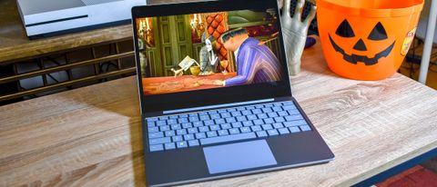 Surface Laptop Go on a coffee table next to Halloween decorations