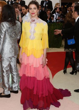 Princess Charlotte Casiraghi of Monaco wears a yellow, pink and red ruffled dress at the Met Gala 2016