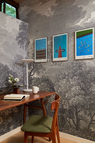 a small home office with bold wallpaper