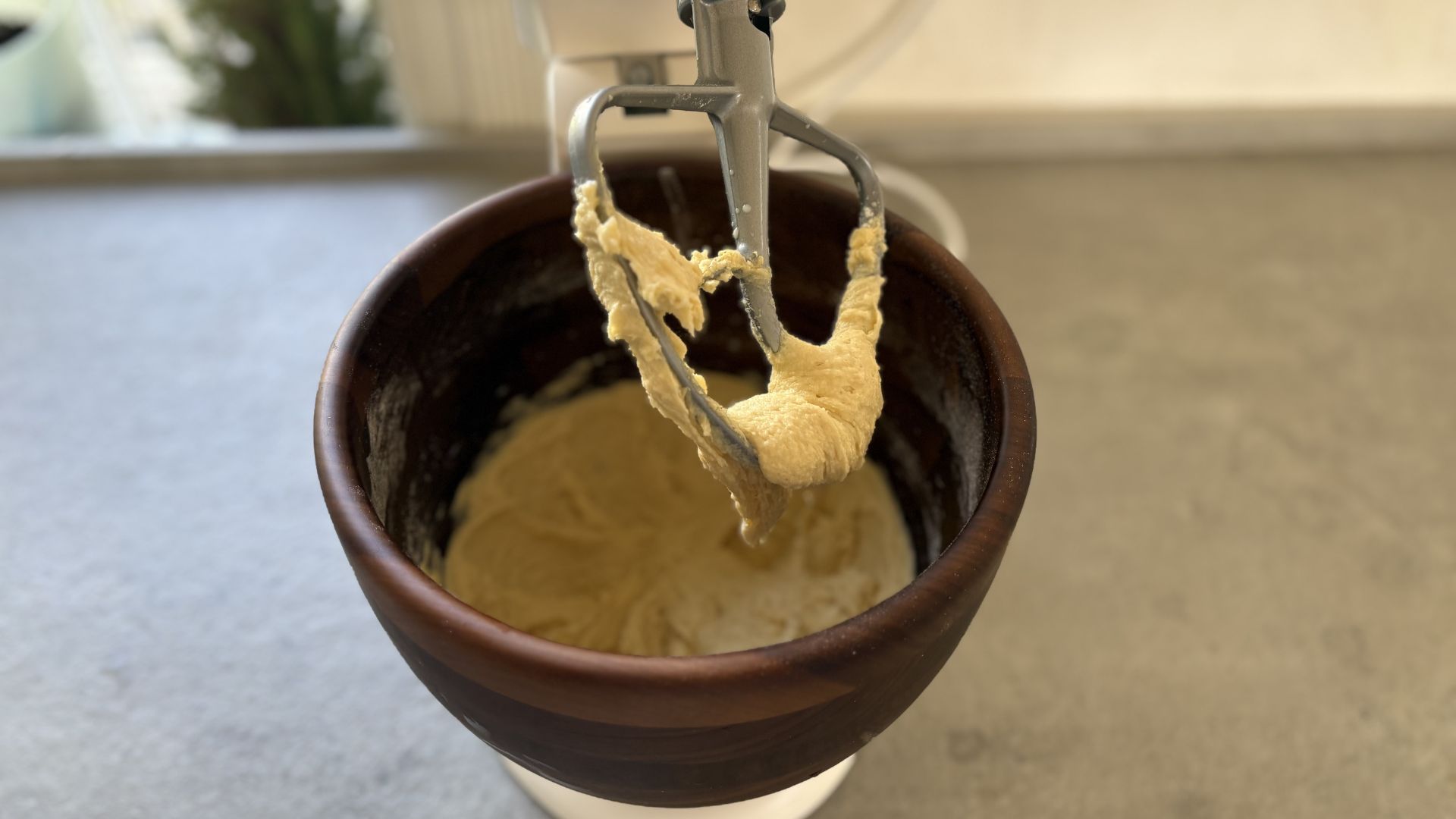 KitchenAid Artisan Stand Mixer with Wooden Bowl on the counter mkaing cake mix