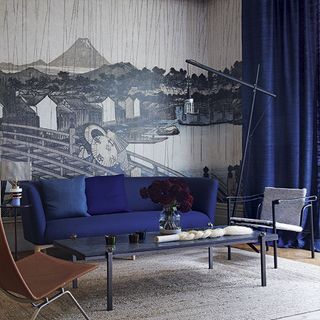 living room with printed walls and blue sofaset with cushions