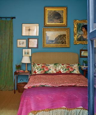 colorful bedroom with teal walls, patterned bedding and artwork