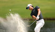 Min Woo Lee hits a bunker shot