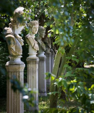 traditional stone busts on plinths as garden feature ideas