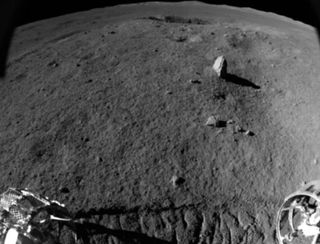 This photo taken by China's Yutu 2 moon rover shows the elongated "milestone" rock on the lunar surface.
