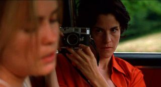 Ally Sheedy takes a photo of Radha Mitchell in a car