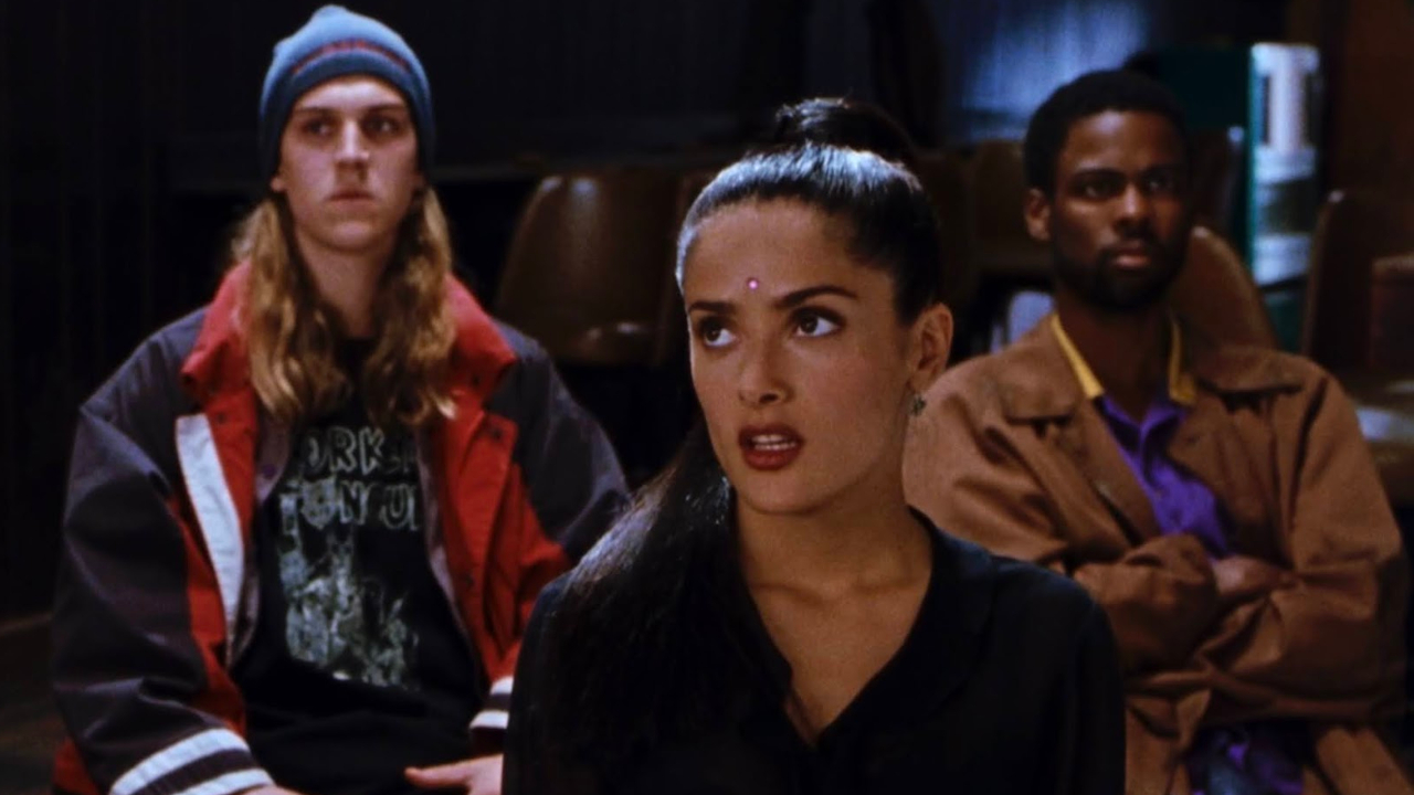 Jason Mewes and Chris Rock sit behind an unimpressed looking Salma Hayek in Dogma.