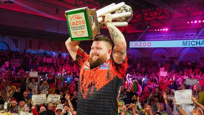 Darts world champion Michael Smith poses with the Sid Waddell Trophy  