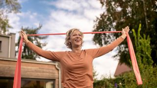 A woman uses a resistance band