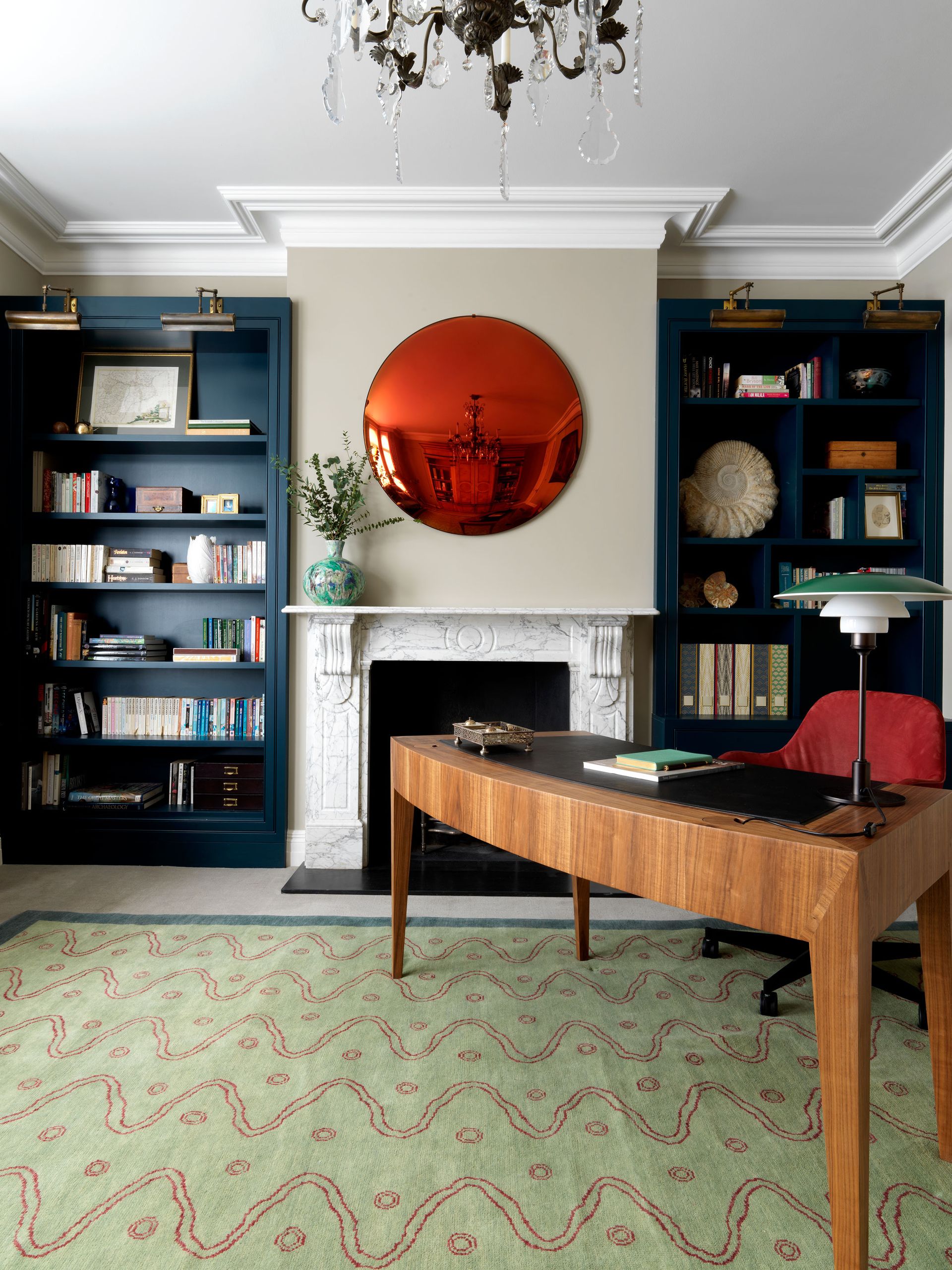 Blue office with pops of colour and a rustic fireplace