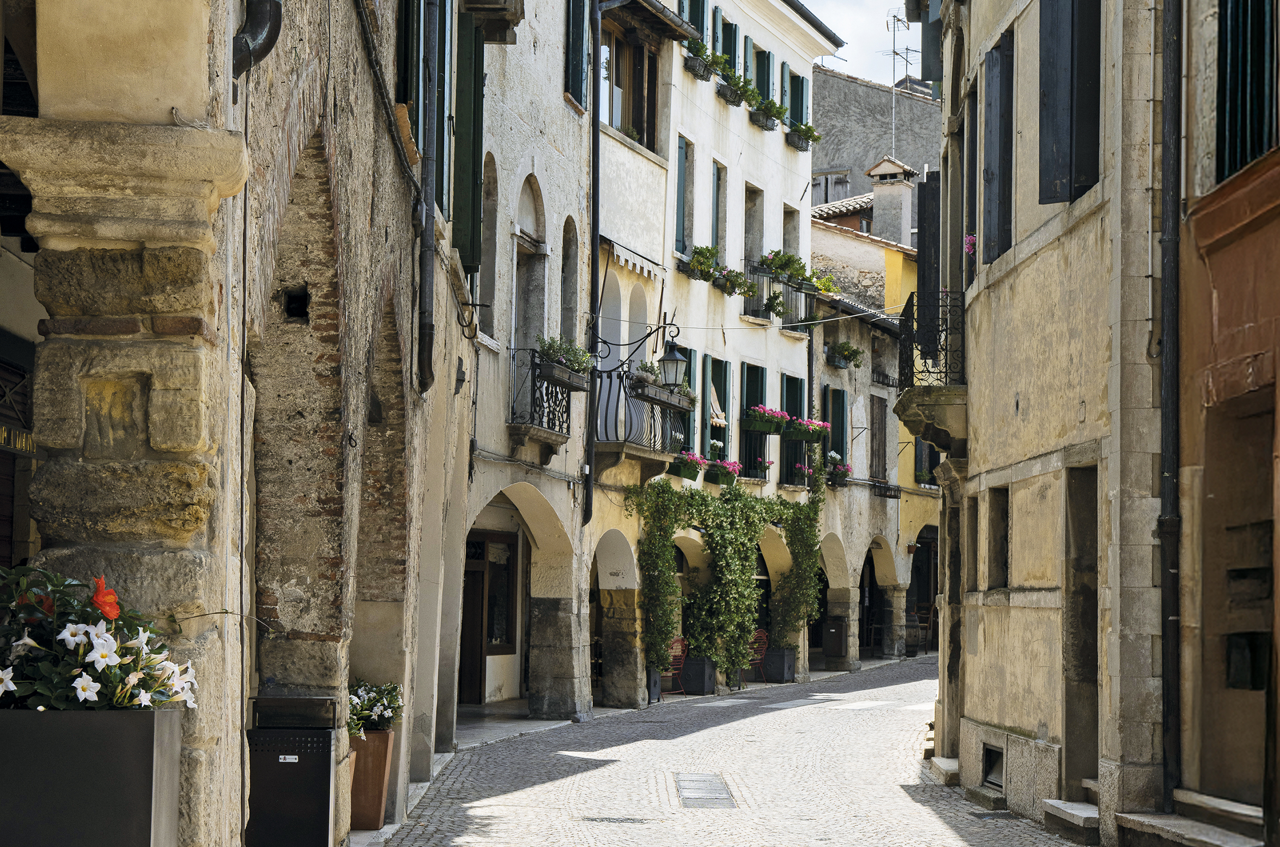 View down a small street with old buildings with arched doorways