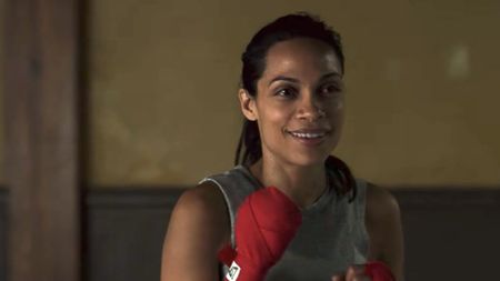 Claire Temple smiling with her hands wrapped for boxing. 