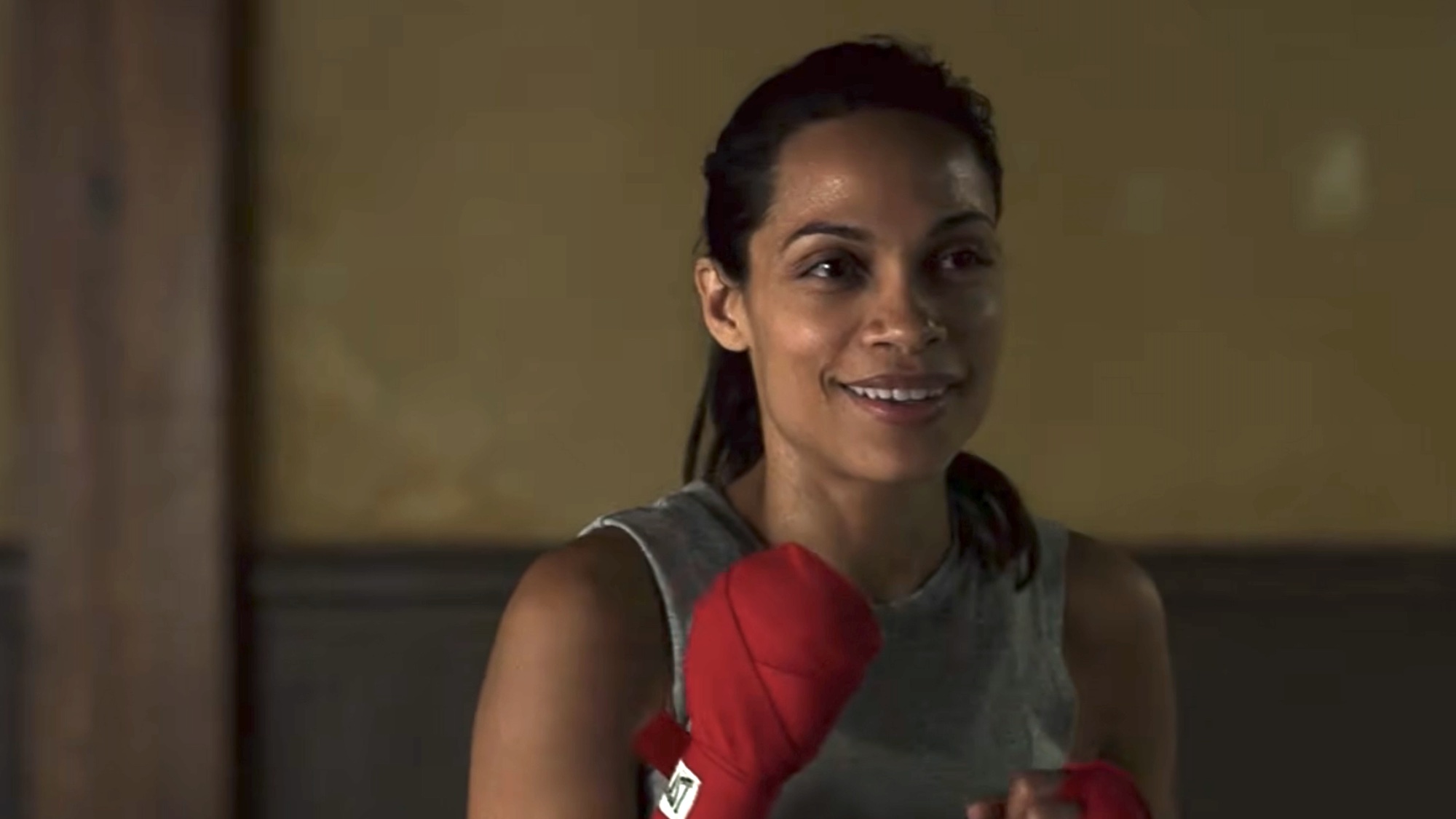 Claire Temple smiling with her hands wrapped for boxing. 