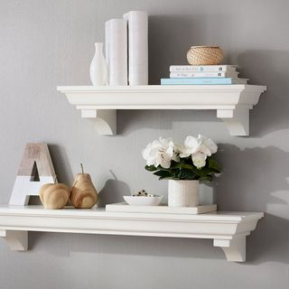 Traditional style shelving units with ornaments on