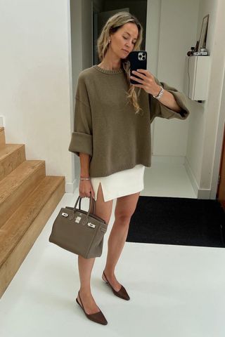 Anouk Yve wearing brown jumper and white mini skirt