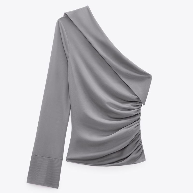 flat lay of zara grey ruffled asymmetric top